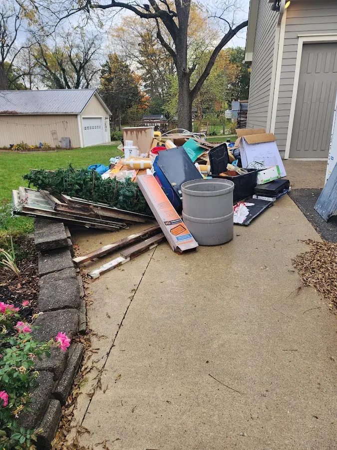 Dumpster being loaded with debris for 10 Yard Dumpster Rental in Port Isabel